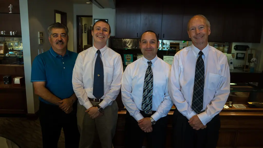 Four members of the Melby's staff posed together behind the counter